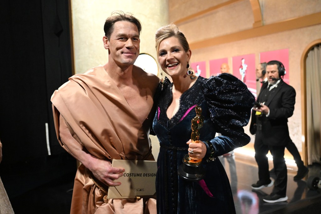 holly-waddington-wins-best-costume-design-oscar-for-‘poor-things’-with-an-auspicious-introduction-by-john cena