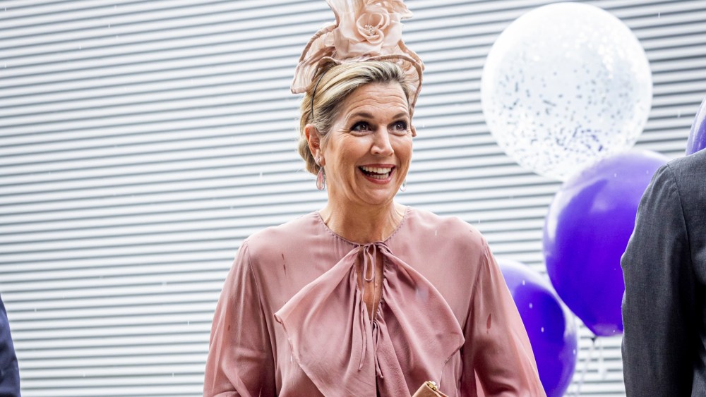 queen-maxima-of-the-netherlands-opts-for-whimsical-dressing-in-playful-dusty-rose-dress-and-floral-hat-at-amsterdam college