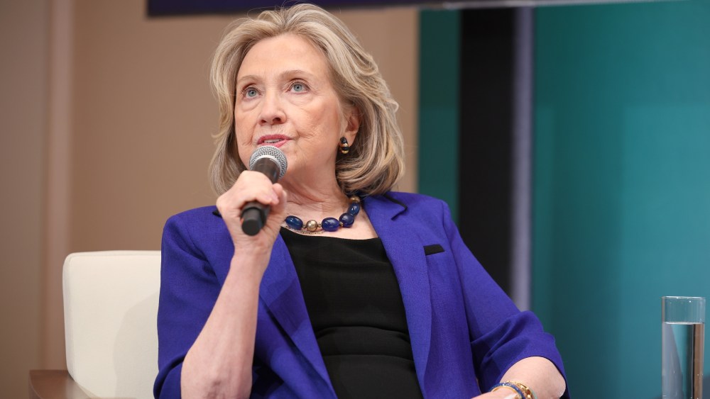 hillary-clinton-embraces-statement-suiting-with-vibrant-purple-blazer-and-accessories-at-vital-voices-global-festival 2024