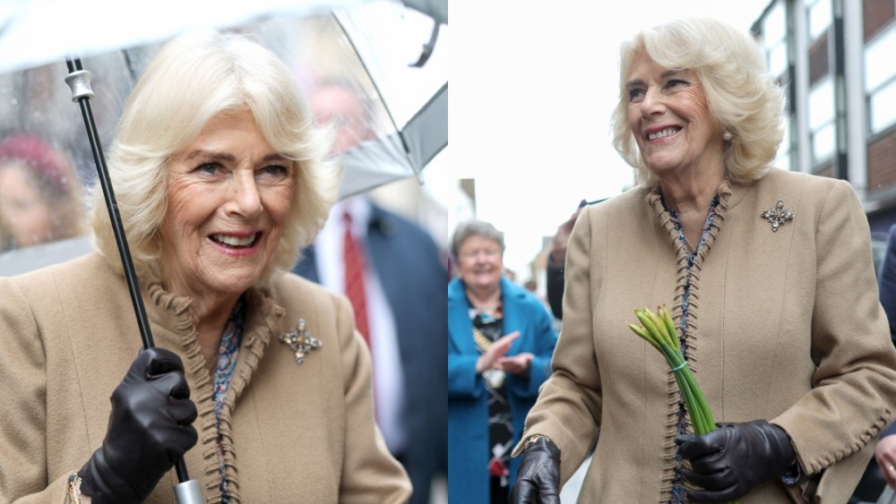 queen-camilla-styles-anna-valentine-coat-with-white-and-yellow-gemstone-cross-brooch-for-a-royal-visit-to canterbury